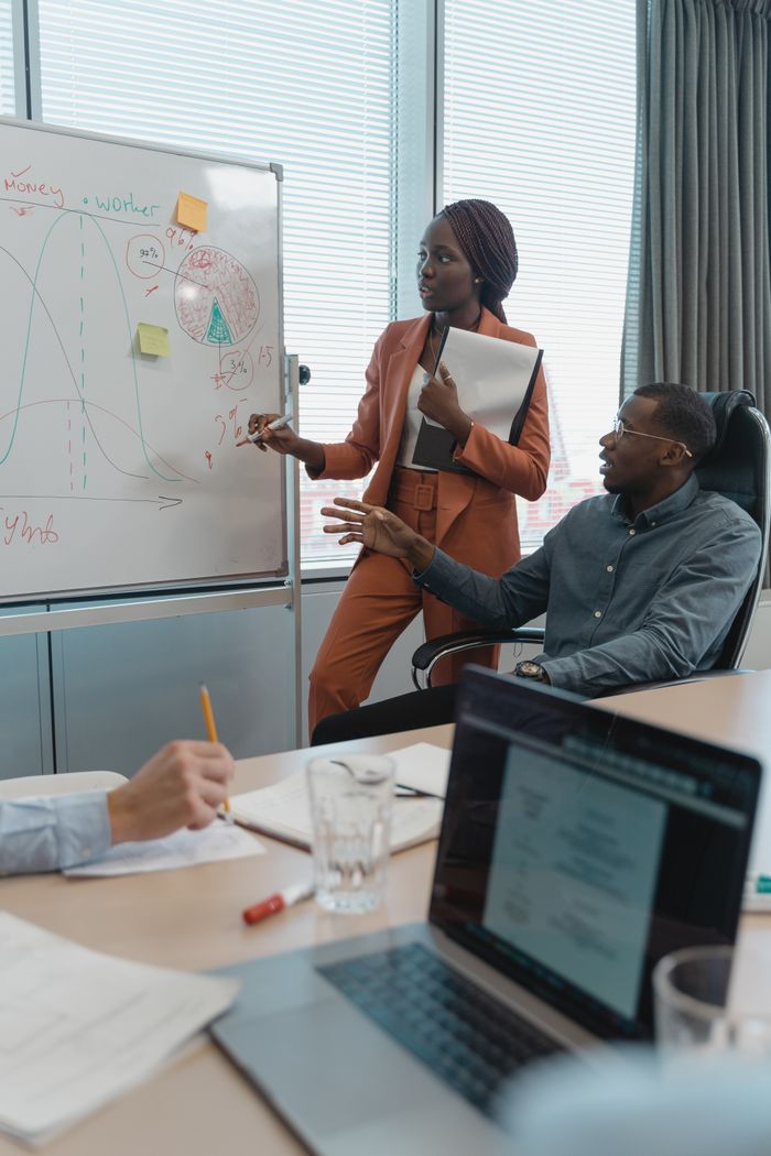 about-us A diverse team discusses strategies during a meeting in a modern office setting.
